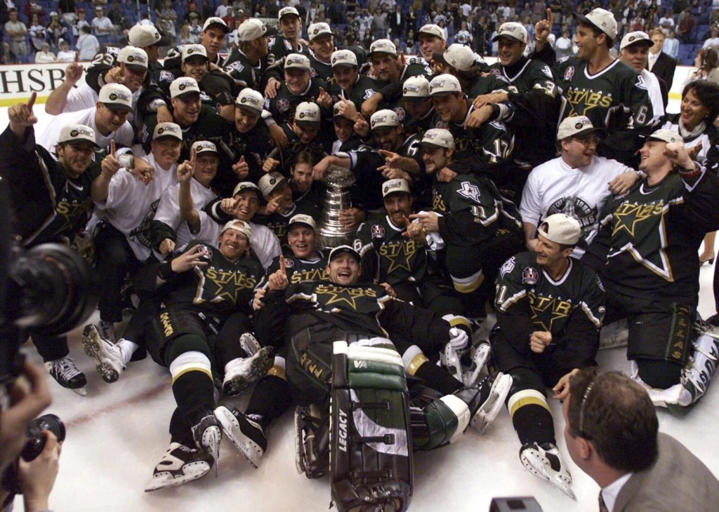 The Dallas Stars pose for a picture with the Stanley Cup after winning it for the first time in 1999.